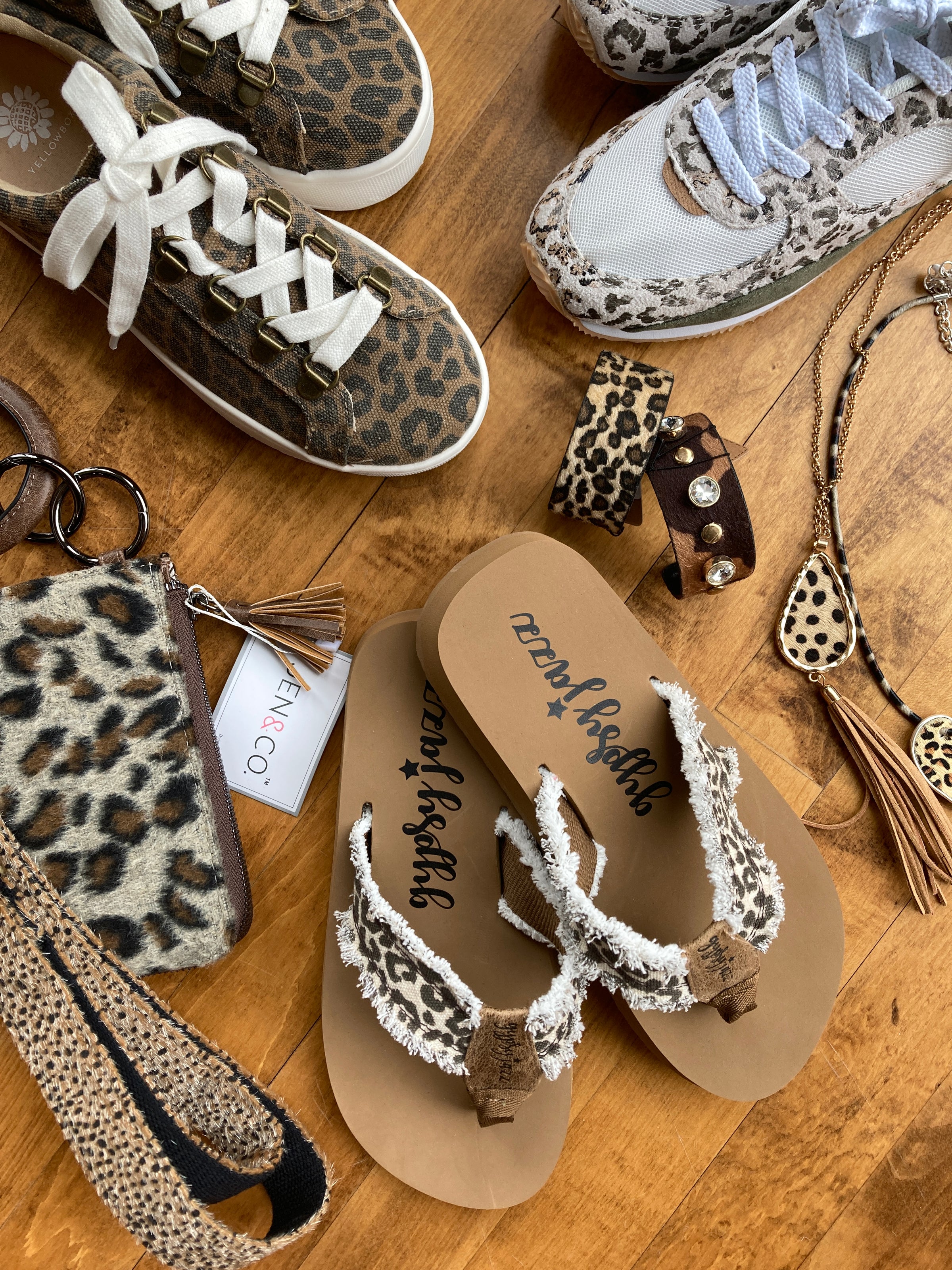 A flat lay of leopard print shoes and accessories