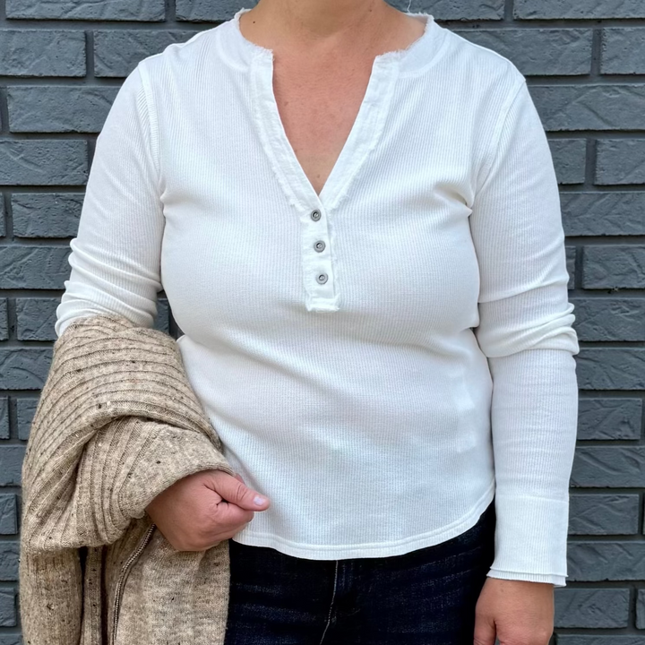 Women's long sleeve V-neck top with button trim and hi-lo hem – model Becky wears a medium, fits true to size.