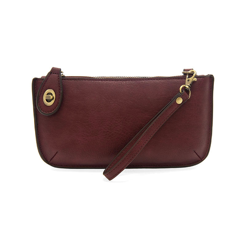 Chic convertible wristlet with zip and turn-lock closure, card slots, and straps—stylish, functional gift for confident women 30+.