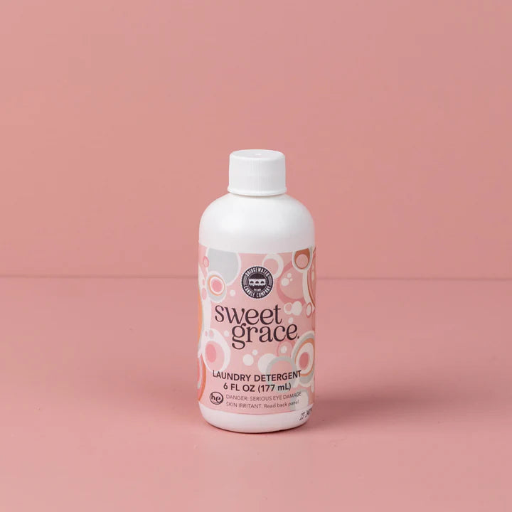 "Sweet Grace Laundry Detergent 6 oz – fabric-safe sanitizing formula with long-lasting oriental & spice scent of passion fruit, sparkling tea, and patchouli."