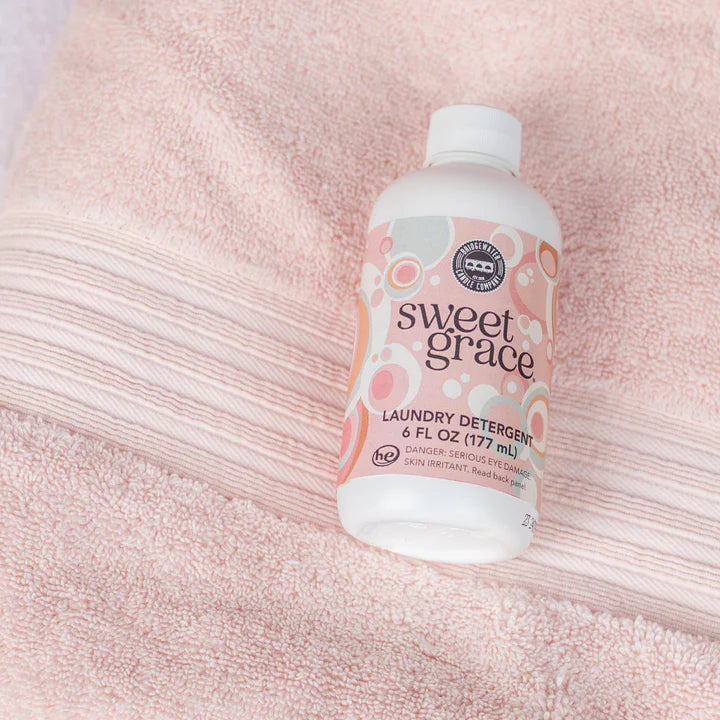 "Sweet Grace Laundry Detergent 6 oz – fabric-safe sanitizing formula with long-lasting oriental & spice scent of passion fruit, sparkling tea, and patchouli."