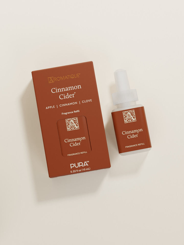Pura Cinnamon Cider fragrance refill smart vial beside its rust-colored box packaging