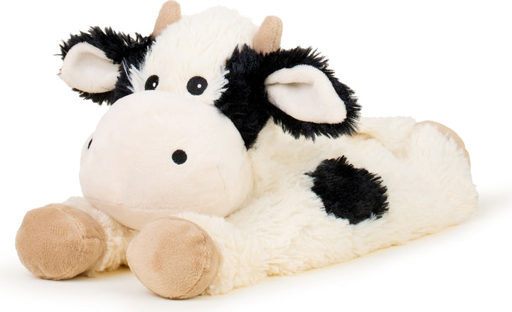 Warmies plush cow stuffed animal with white body and black spots in laying position