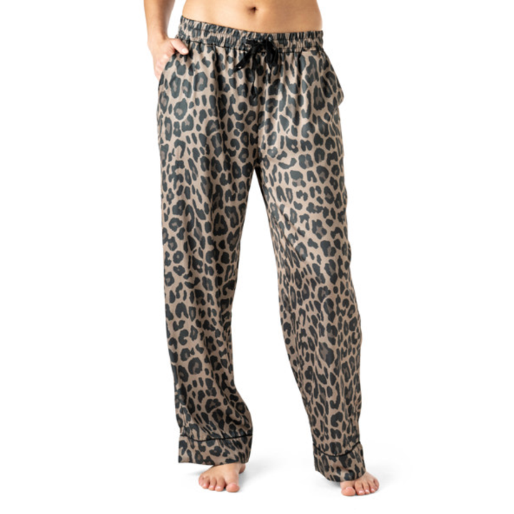 Woman wearing leopard print satin pajama pants with drawstring waist