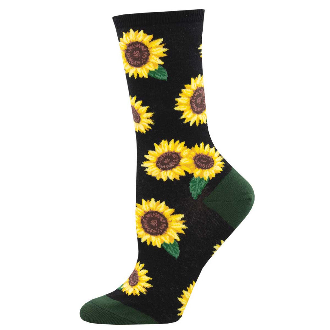 Socksmith black crew socks featuring large yellow sunflower pattern with green accents