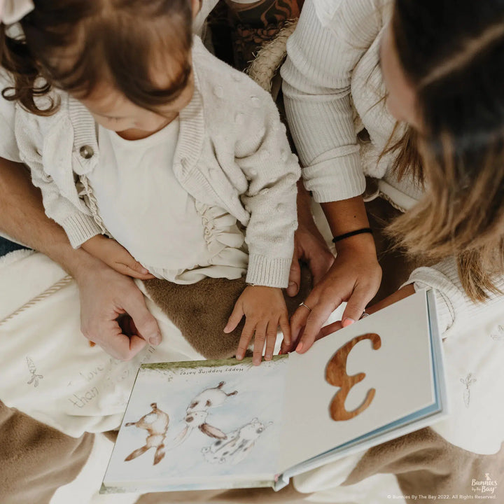 Bunnies by the Bay Hares Play counting book open showing illustrated hopping hares and number 3
