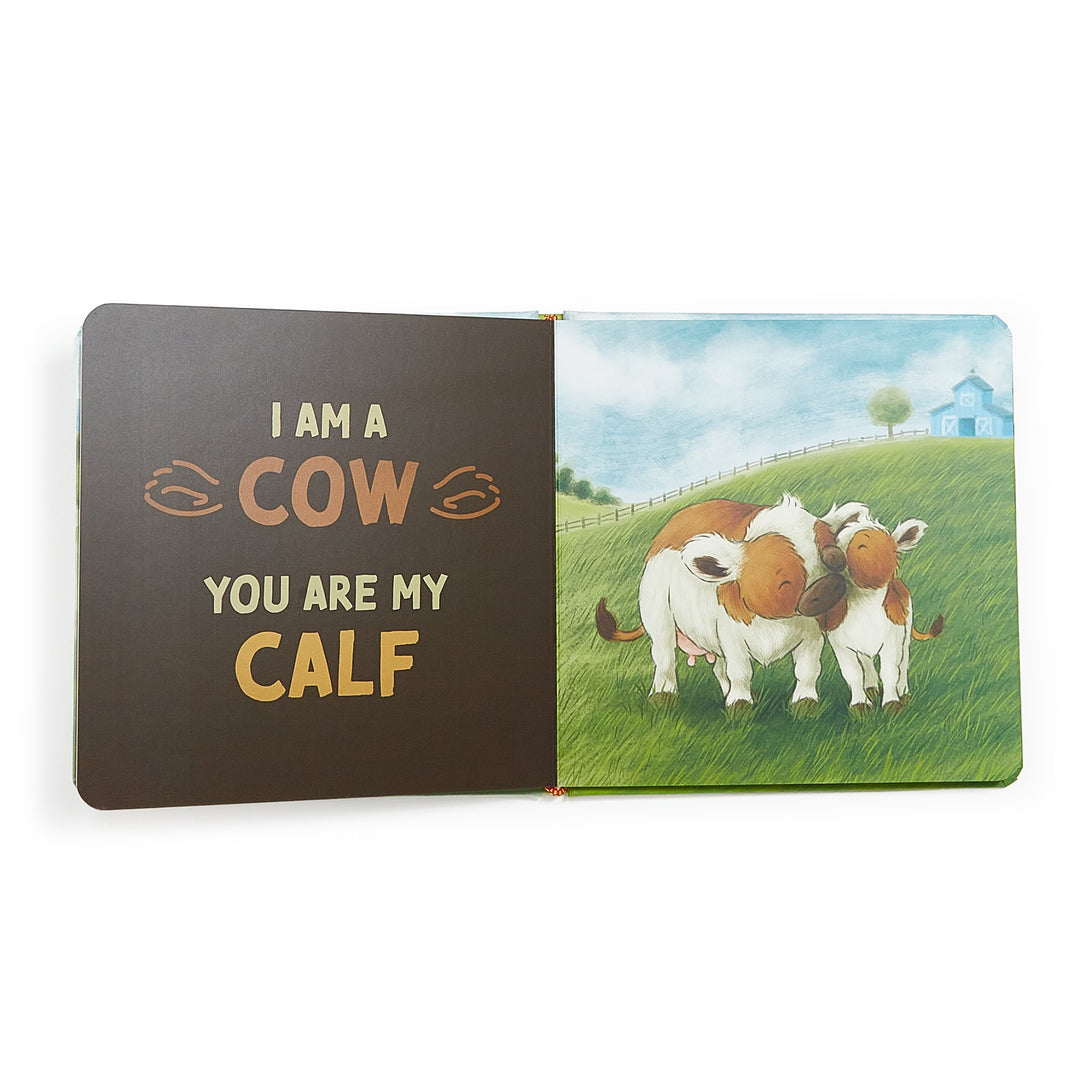 Open board book showing cow and calf illustration with text 'I Am A Cow, You Are My Calf'