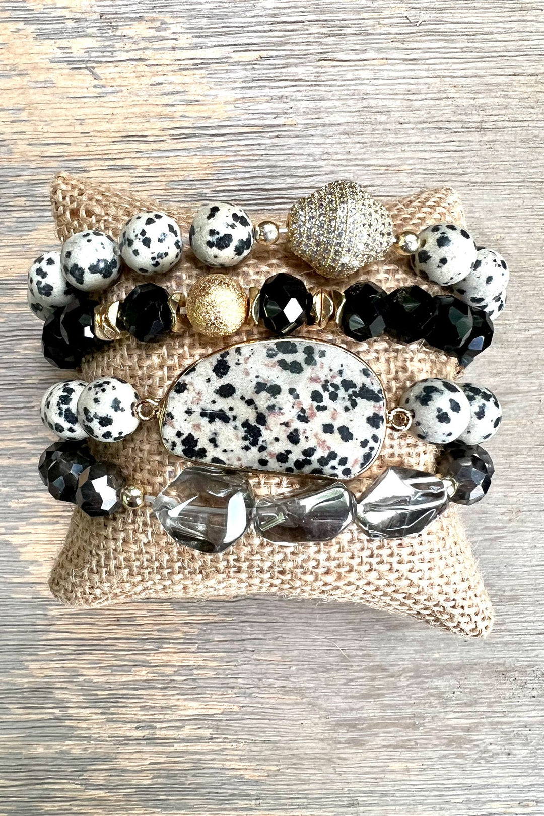 Set of four stretch bracelets with dalmatian jasper, black crystals, and gold accents