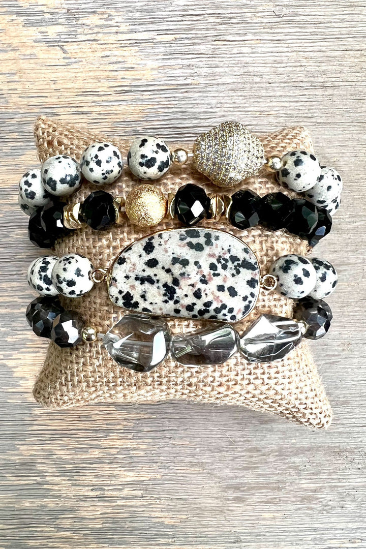 Set of four stretch bracelets with dalmatian jasper, black crystals, and gold accents