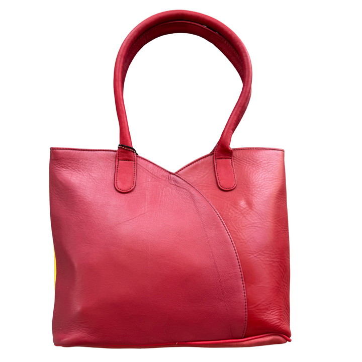 Recycled leather shoulder bag with color-block reversible design, zip closure & roomy interior—stylish, eco-smart pick for women 30+.