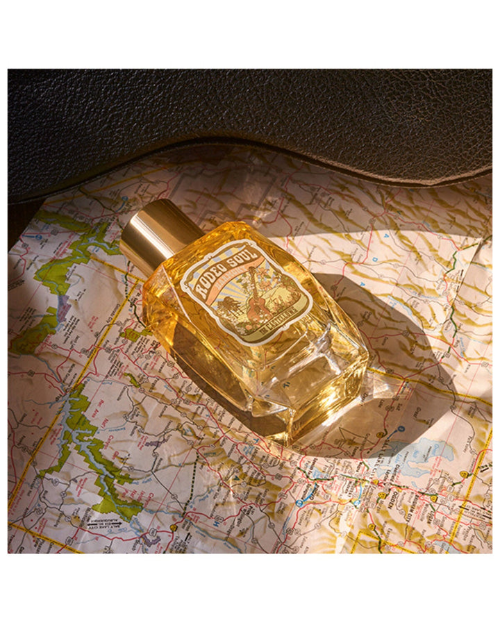 Rodeo Soul EDP 100ML Harmony by Tru Fragrance in golden amber bottle on vintage map