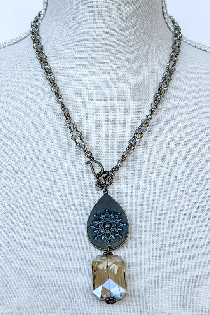 Bronze necklace with blue mandala teardrop pendant and faceted champagne crystal drop