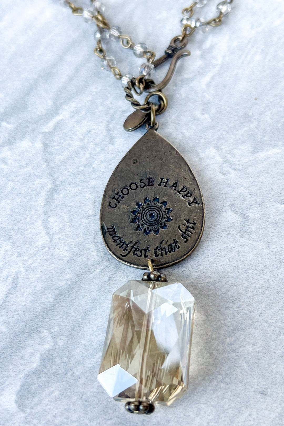 Bronze teardrop necklace engraved with Choose Happy and a clear crystal pendant
