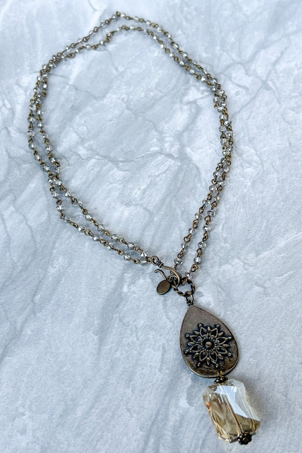 Bronze double-strand crystal chain necklace with filigree teardrop pendant and faceted crystal drop