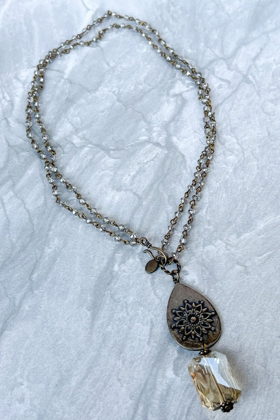 Bronze double-strand crystal chain necklace with filigree teardrop pendant and faceted crystal drop