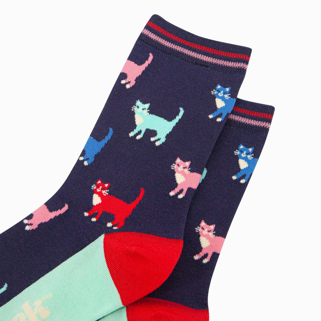 Navy bamboo crew socks with colorful cat pattern and red heel detail