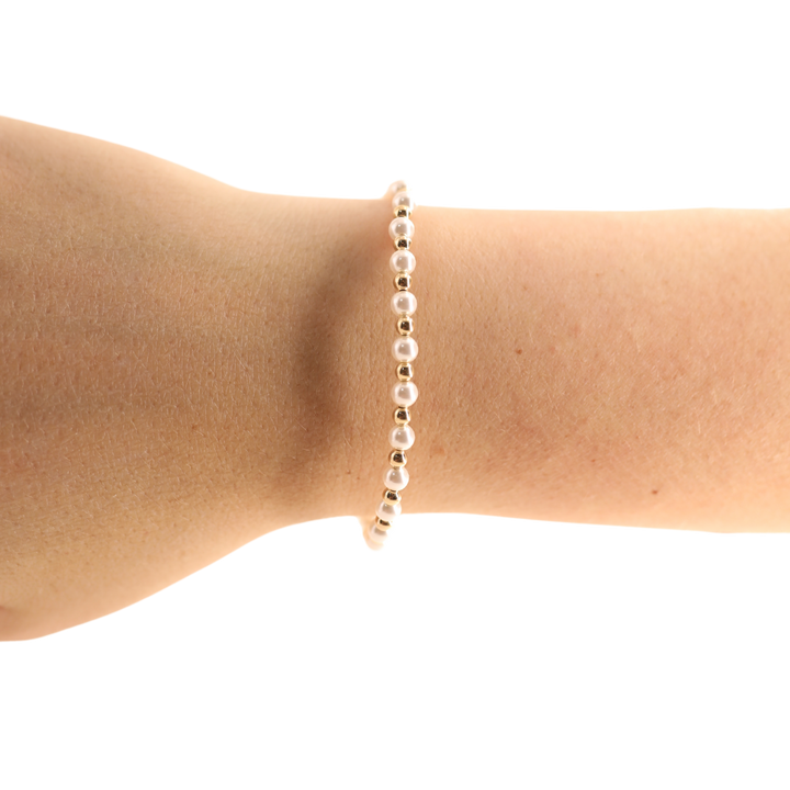 Beaded Blondes Luci Pearl Bracelet in gold and white pearl beads worn on wrist