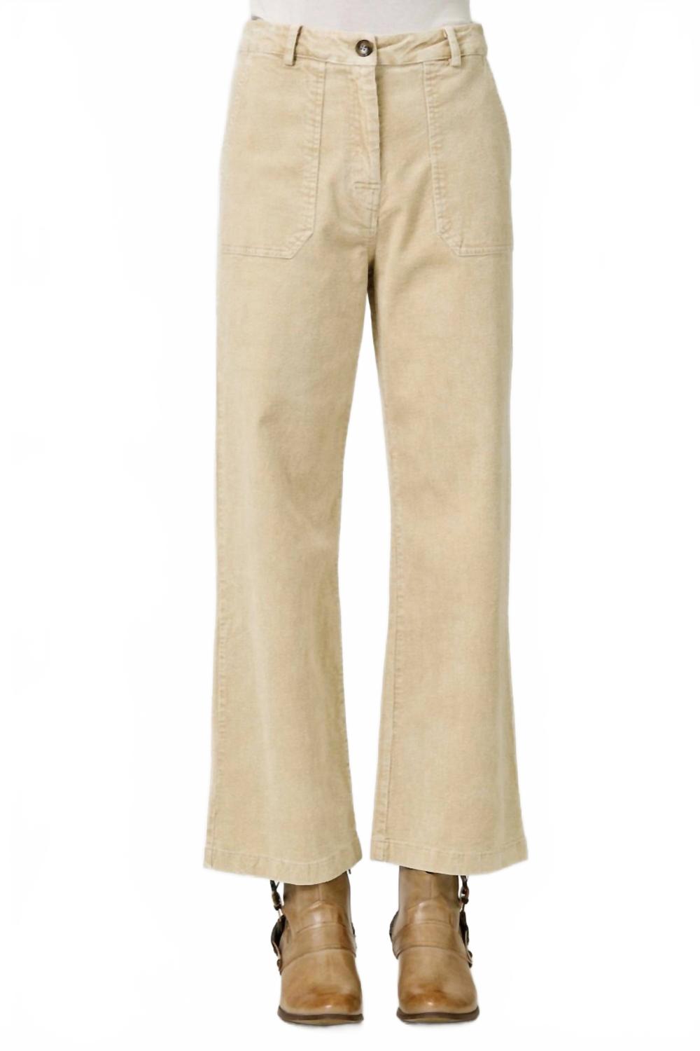 Beige corduroy cropped flare trousers with front pockets styled with brown ankle boots