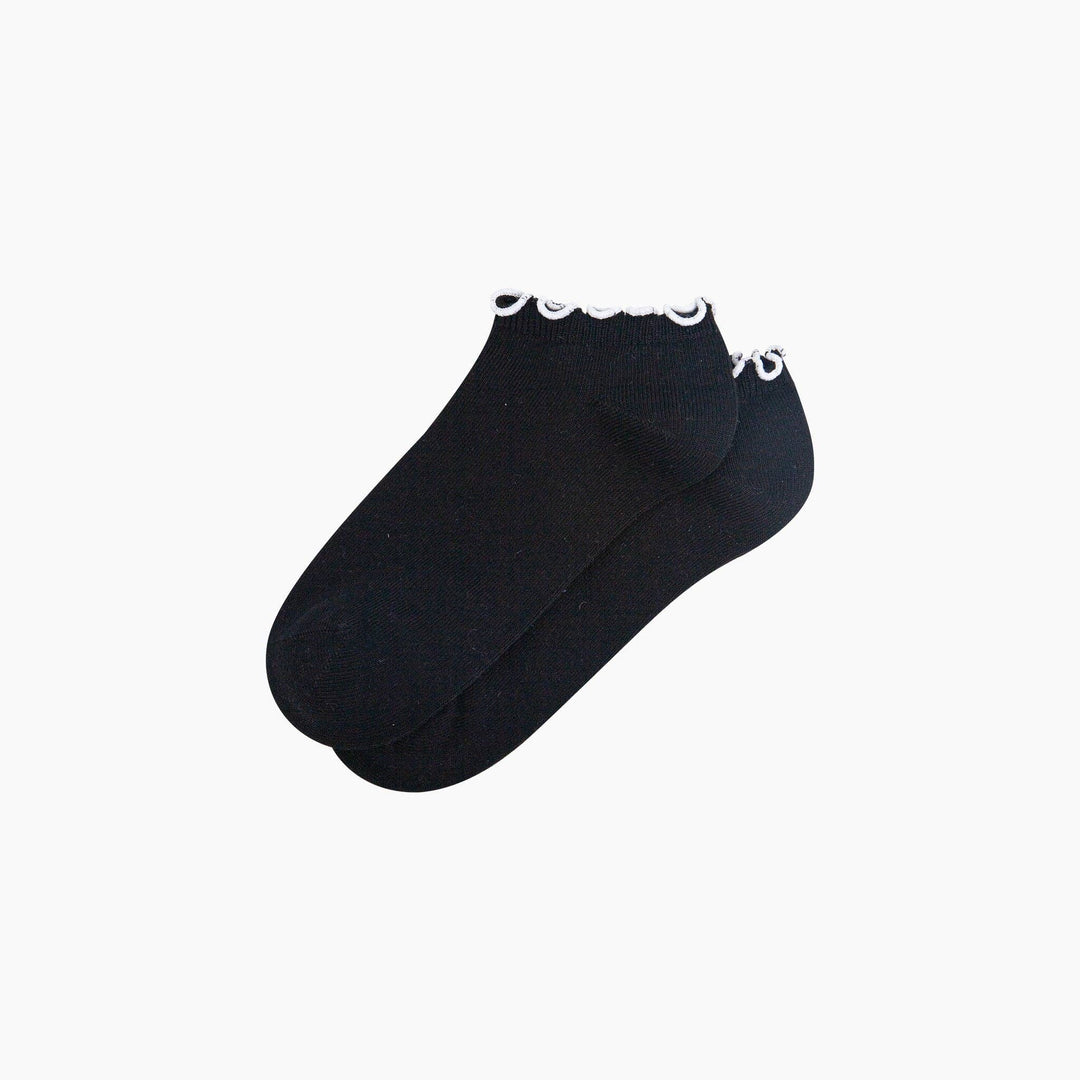 Black ankle trainer socks with white frilly scalloped trim, shown as a pair.