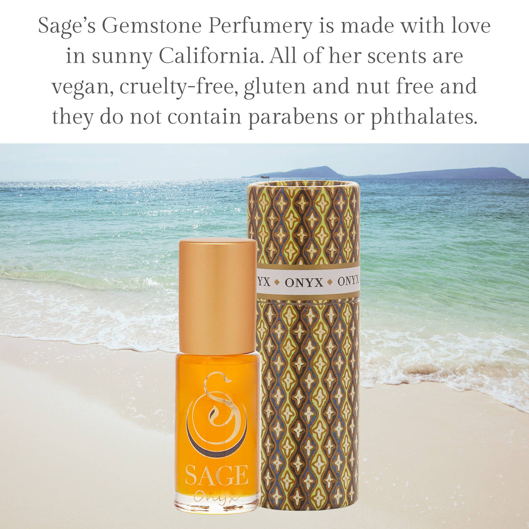 Onyx perfume roller with brown geometric patterned tube and orange bottle on beach