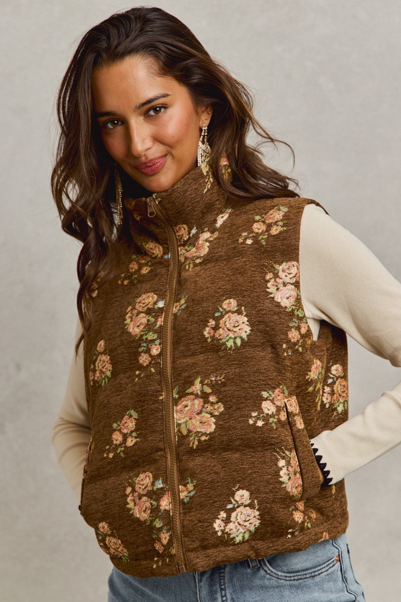 Brown quilted vest with pink floral jacquard pattern worn by model