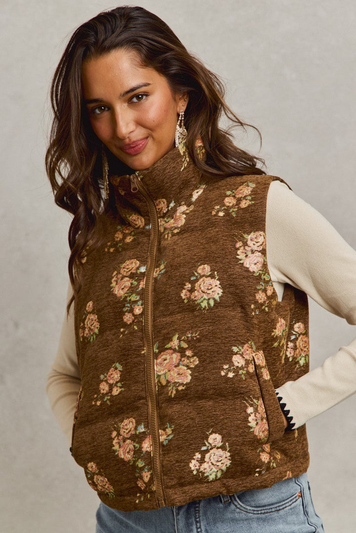 Brown quilted vest with pink floral jacquard pattern worn by model