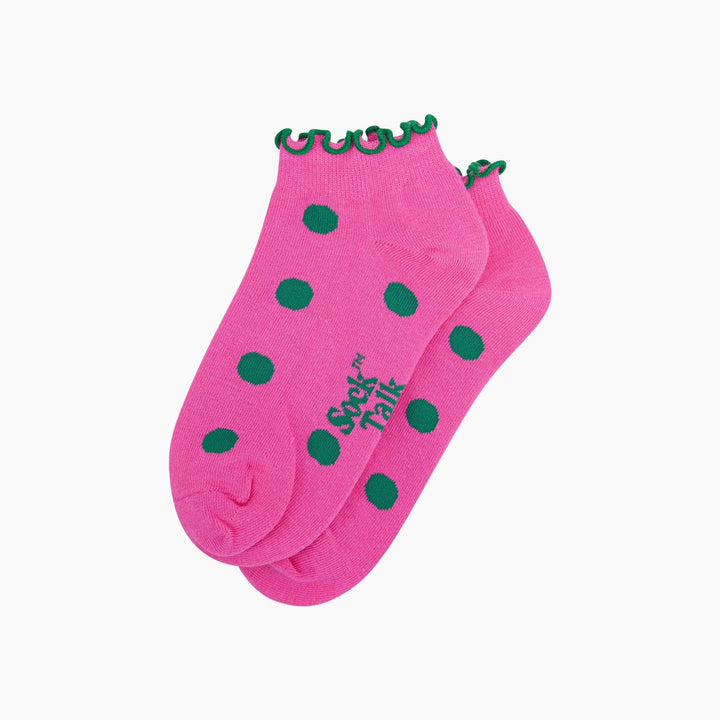 Pink ankle socks with green polka dots and frilled green ruffle cuff, pair shown flat