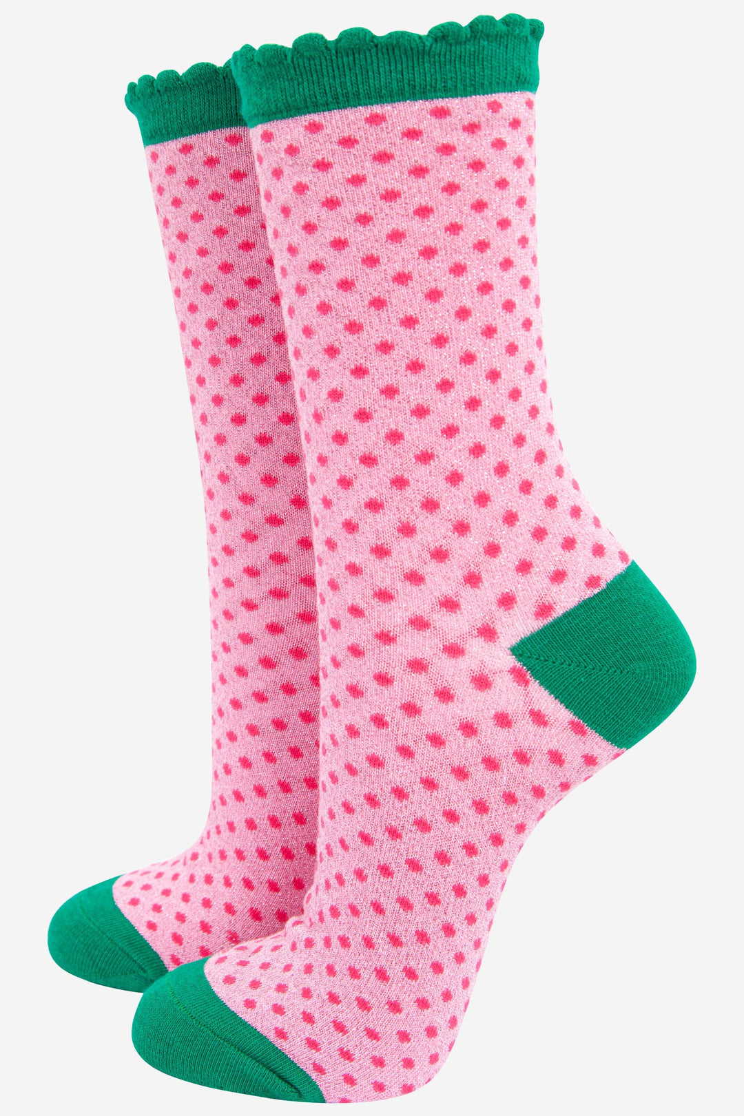 Pink polka dot glitter crew socks with green scalloped cuff, heel, and toe