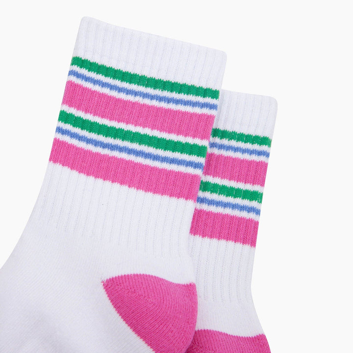 White ribbed crew sports socks with pink, green, and blue stripes and pink heel
