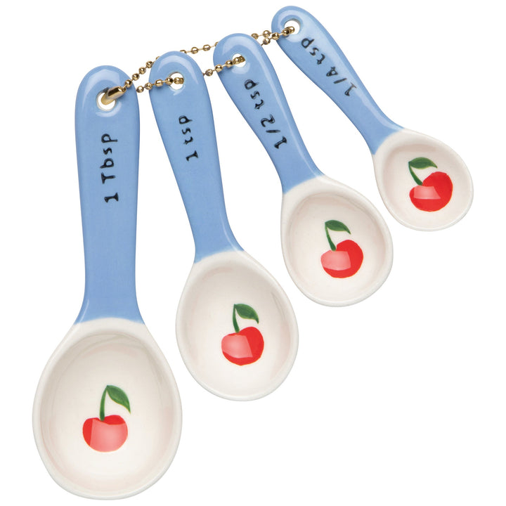 Set of four blue measuring spoons with cherry design and measurement markings
