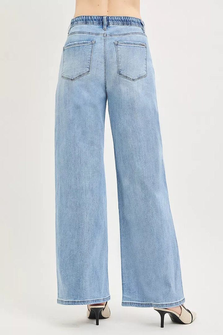 Light blue wide leg jeans with drawstring waist and back pockets shown from behind