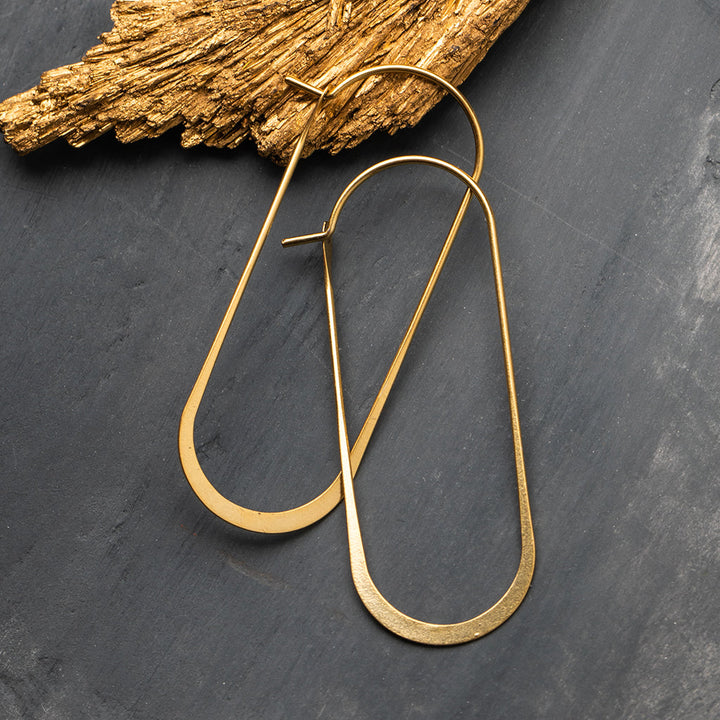 Scout Refined Earring Collection Cosmic Oval gold vermeil elongated hoop earrings displayed on slate