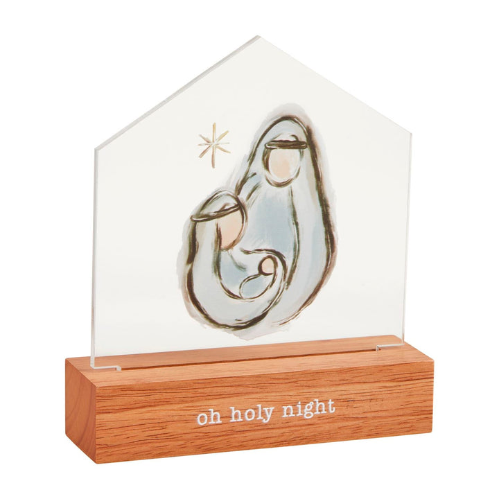 Clear acrylic house-shaped Christmas decoration with nativity scene on wooden base reading oh holy night