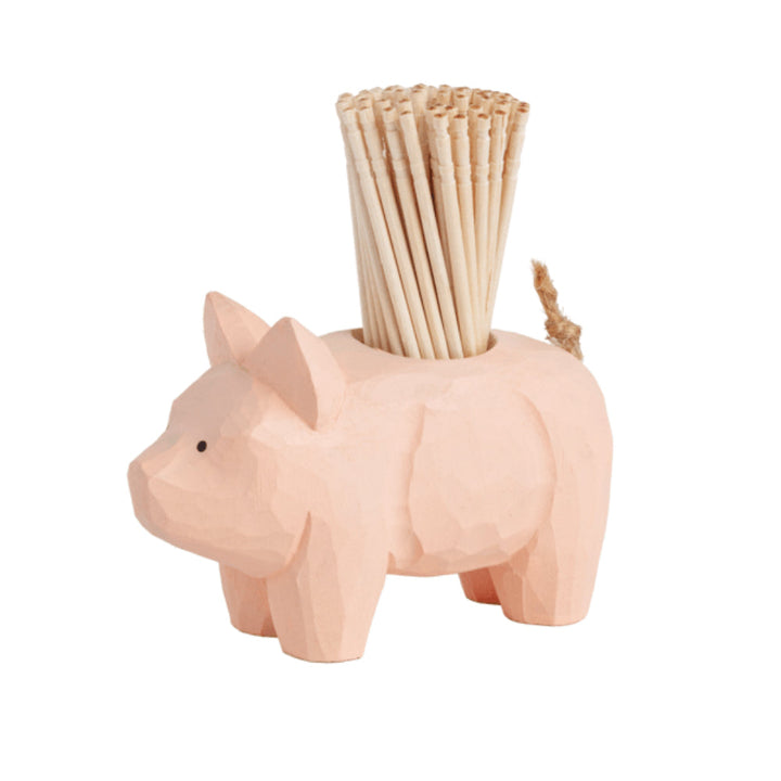 Pink wooden pig-shaped toothpick holder with wooden toothpicks displayed