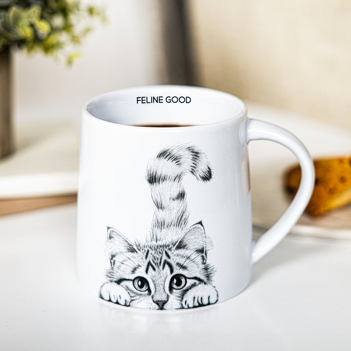 White 17 oz mug with cute kitten illustration and 'FELINE GOOD' text