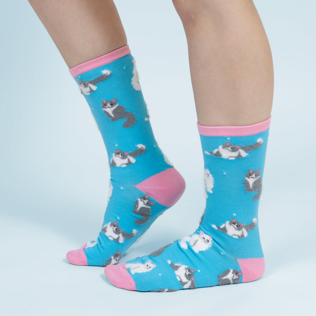 Turquoise blue socks with white and gray cat pattern and pink accents