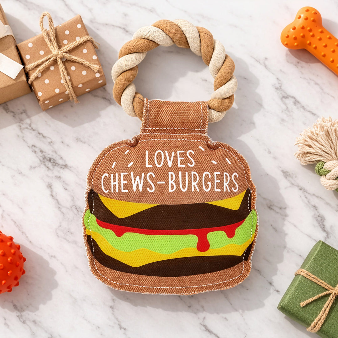 Dog rope toy shaped like hamburger with text 'Loves Chews-Burgers' on brown bun