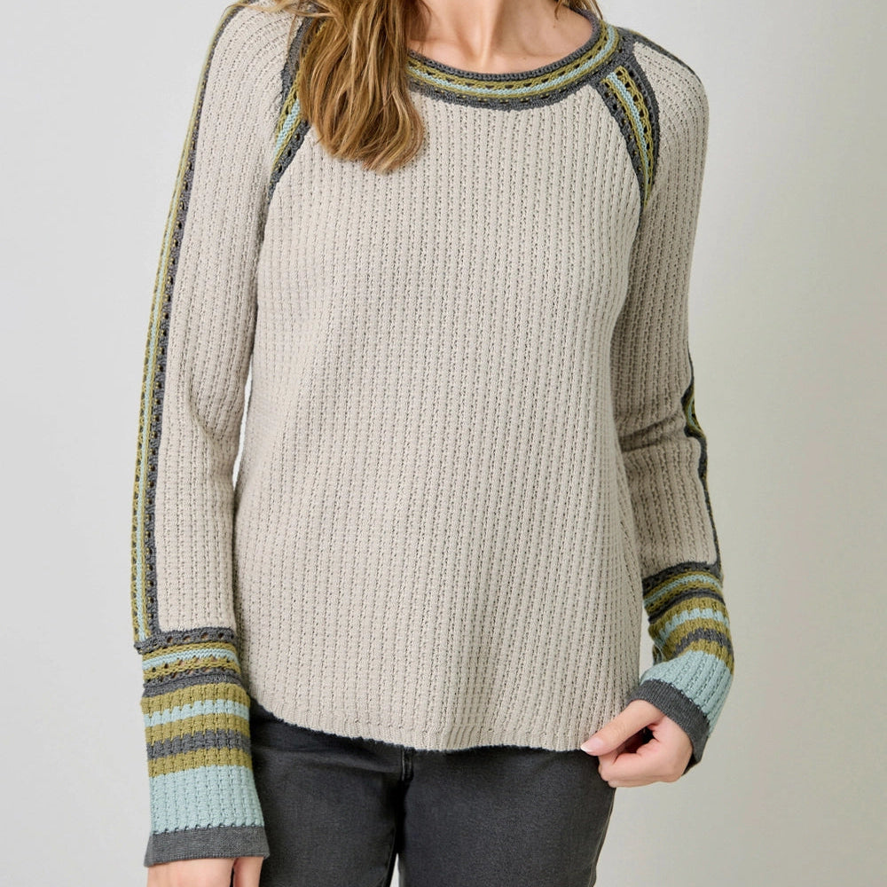 Women's round neck top with long sleeves featuring contrast stripes and a hi-lo hem.

