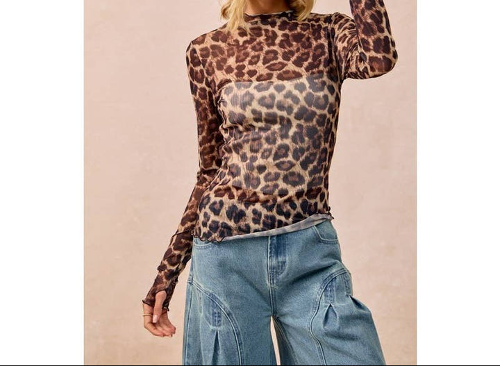 Woman wearing leopard print mesh long-sleeve top with cowboy hat and jeans