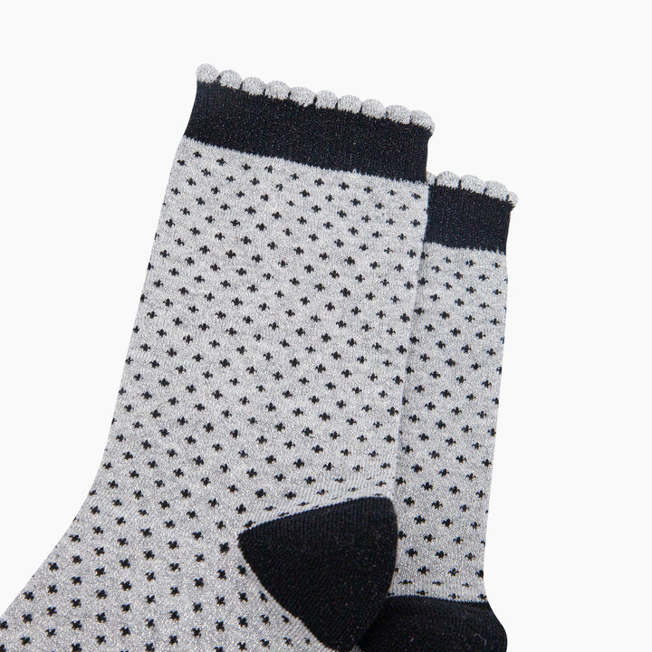 Grey glitter crew socks with black polka dots, scallop cuff, and black heel detail