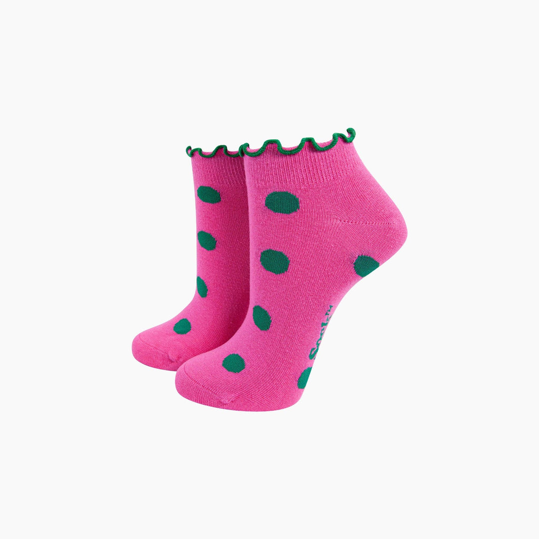 Pink ankle socks with green polka dots and frilled green cuff trim