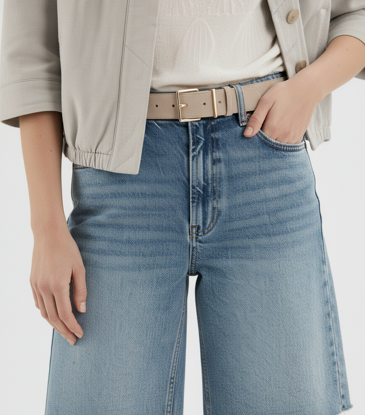 Most Wanted Springtime Belt in Toasted Almond with sharp angular gold buckle on model wearing jeans
