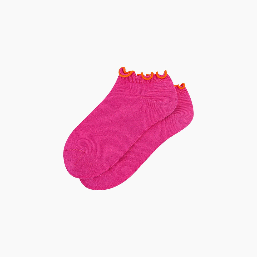 Pink ankle socks with orange frilly ruffle trim, pair laid flat
