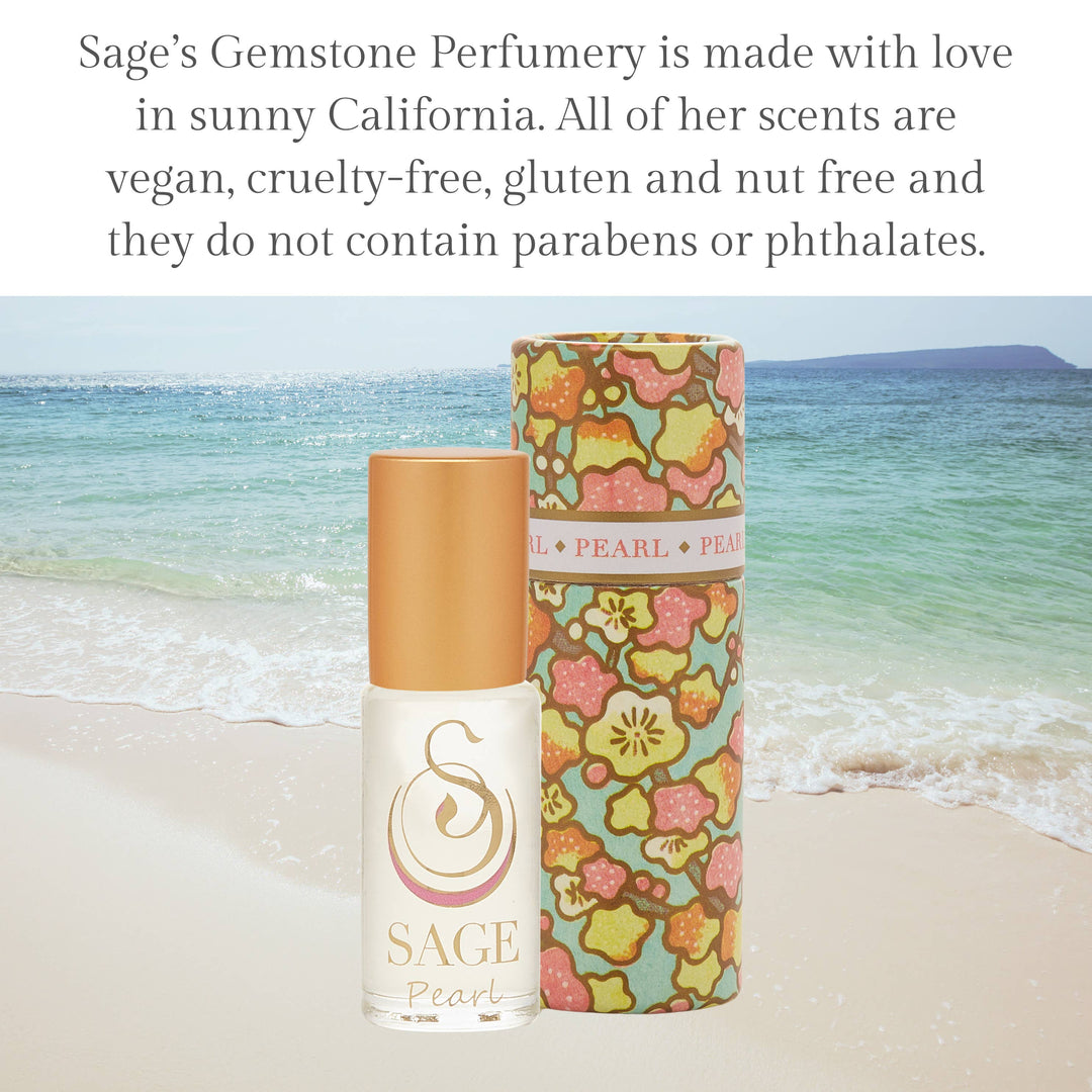Sage Pearl perfume roller with floral patterned tube on beach background