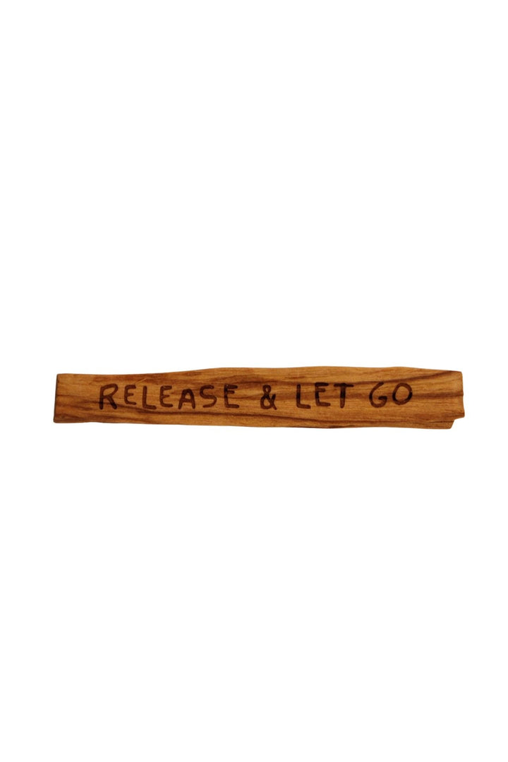 Sugarboo Palo Santo stick with 'Release & Let Go' mantra burned into wood surface