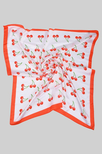 White square scarf featuring red cherry print pattern with red border trim edges