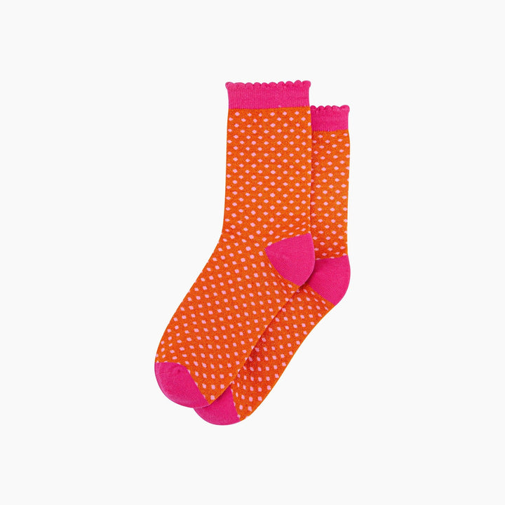 Orange glitter crew socks with pink polka dots, hot pink heel, toe, and scalloped cuff