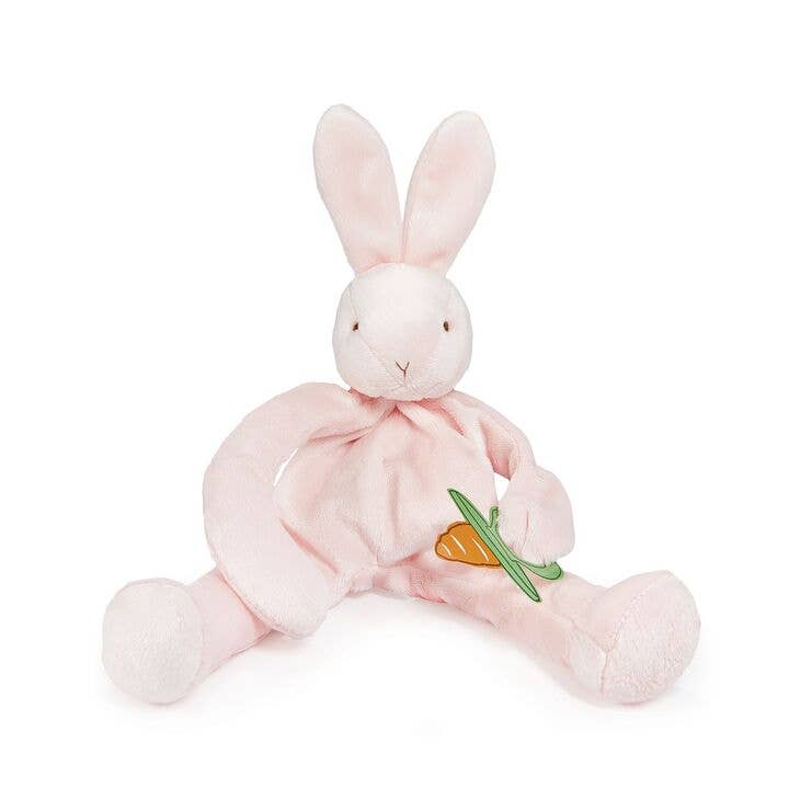 Soft pink plush bunny toy with carrot detail sitting against white background