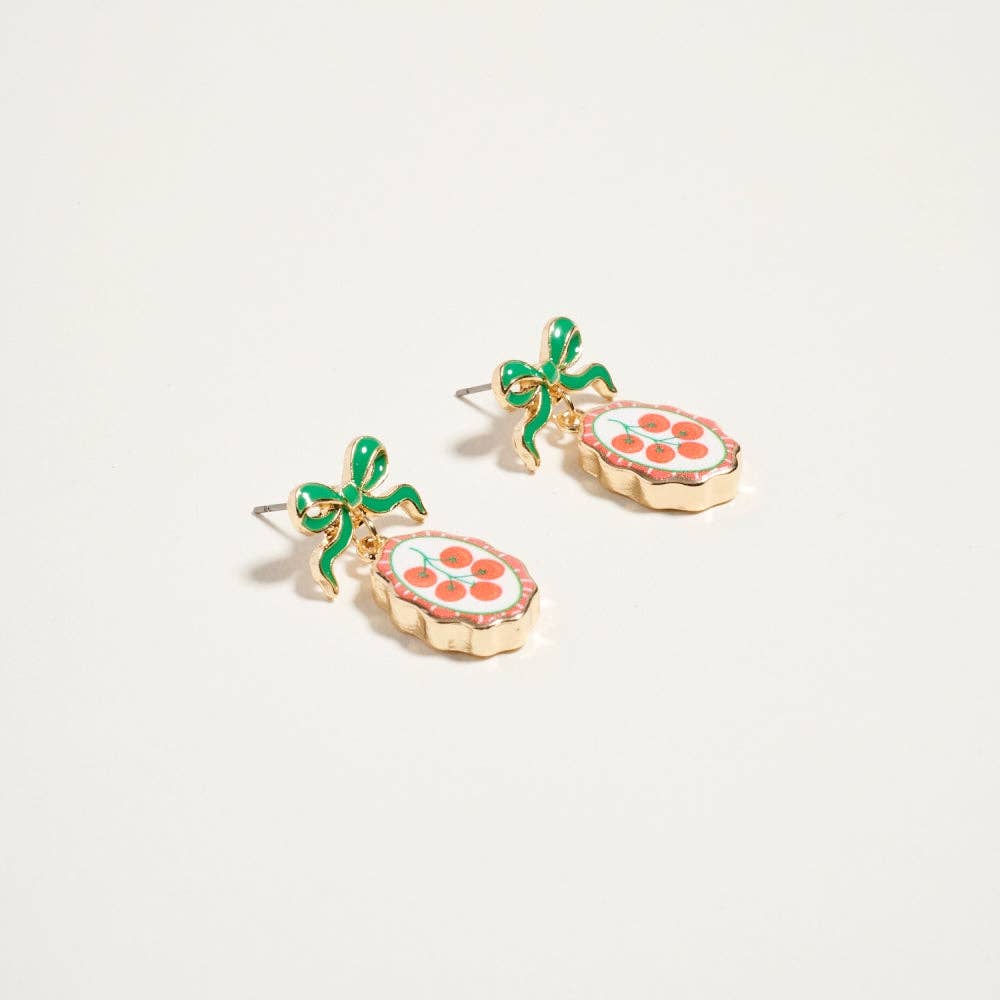 Gold drop earrings with green enamel bow and oval tile charm featuring red tomato fruit print