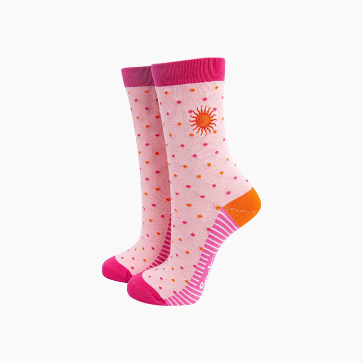 Pink crew socks with orange and pink polka dots, embroidered sun, and hot pink cuffs